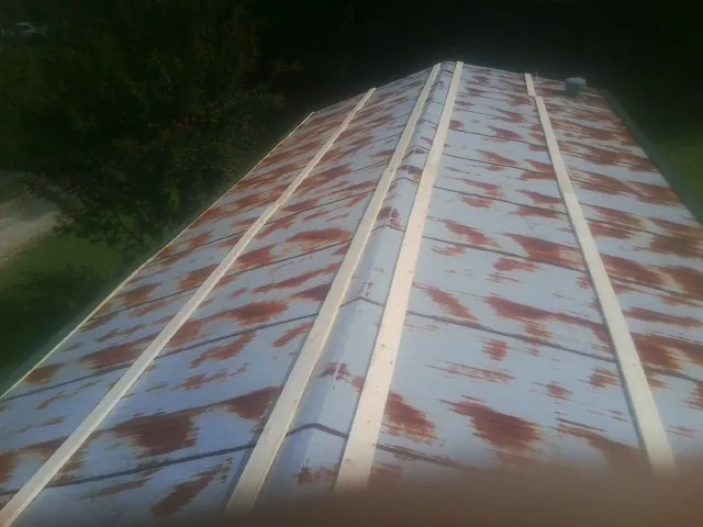 Rusted metal roof panels with new wood purlins before replacement — Storm Damage Roof Repair in Wawarsing by Roofing Brothers